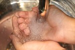 Washing Hands Under Faucet